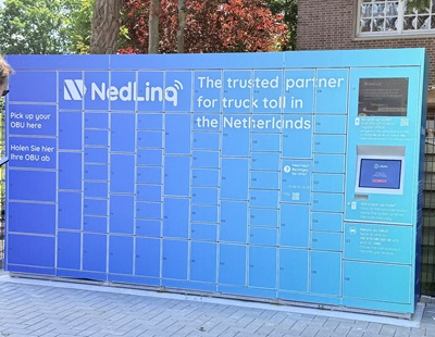 Een grote blauw kast (pakketwand), met een NedLinq-logo. De kast bestaat uit ongeveer 80 kleine kasten met afgesloten deuren. Rechts op de pakketwand zit een aanraakscherm.